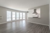 Located in the vibrant Highland Park neighborhood of Los Angeles, this single-floor unit at 5515 Ash St offers a clean, modern aesthetic with thoughtfully updated interiors. The open-concept living and dining area is bright and airy, bathed in natural light streaming through a bank of wide windows fitted with white plantation blinds. Warm wood-look vinyl flooring runs continuously throughout the space, complementing the soft gray walls and white trim for a cohesive, contemporary feel. A pendant light anchors the living area, adding a stylish focal point above the open layout. The kitchen is a standout feature, boasting white shaker cabinetry, light quartz countertops, and a striking geometric hexagonal tile backsplash. Stainless steel appliances — including a gas range, dishwasher, and refrigerator — are paired with a matte black faucet and undermount sink, while a stainless steel range hood provides both function and visual appeal. Rich, dark hexagonal floor tiles in the kitchen create a bold contrast against the otherwise light palette. A separate bedroom offers a quiet, well-proportioned retreat with its own window and the same consistent flooring. The entry area provides ample clearance with two interior doors and large windows that fill the space with additional natural light.