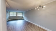 Located at 106 Kane St in West Hartford, CT, this well-appointed 2-bedroom, 2-bathroom residence offers a clean, modern aesthetic throughout its single-floor layout. The open living area features durable wood-look flooring, crown molding, and a striking multi-arm chandelier, with natural light streaming in through blinded windows. A wall-mounted mini-split unit provides efficient climate control alongside baseboard heating.

The kitchen is a functional standout, outfitted with white shaker cabinetry, granite countertops, stainless steel appliances including a dishwasher and refrigerator, and pendant lighting. A built-in granite breakfast bar extends into the dining area, which is illuminated by its own chandelier and connects seamlessly to the living space.

The primary bedroom is generously sized with large windows, wood-look flooring, a mini-split unit, and direct access to multiple doors including a dedicated bathroom. The second bedroom features plush carpeting, a built-in closet, and ample natural light. Both bathrooms are cleanly finished, with one showcasing a modern vanity with an integrated sink, LED-lit mirror, and a full tub-shower combination. The space also includes a dedicated closet, completing this move-in-ready home.