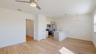 This contemporary townhouse in Lakewood Ranch offers 1160 square feet of living space across two floors. The property features 2 bedrooms and 3 bathrooms, providing ample space and privacy. The primary bedroom is particularly spacious at 220 square feet, offering a luxurious retreat.

The interior is characterized by its modern design and functional layout. Light-colored hardwood flooring runs throughout, complementing the crisp white walls and creating a bright, airy atmosphere. The kitchen showcases sleek cabinetry, stainless steel appliances, and a generous countertop with a modern sink.

Bathrooms are well-appointed with glass-enclosed showers, modern fixtures, and contemporary vanities. The laundry room is equipped with full-sized appliances and overhead shelving for added convenience and storage.

Storage solutions are abundant, with multiple closets and built-in wire shelving systems. The attached garage provides additional space for vehicles and storage.

The property's exterior features a clean, modern facade and a small yard area. Located in the desirable Lakewood Ranch community, this townhouse offers a blend of style, functionality, and convenience in a sought-after Florida location.