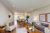 Located at 300 Terrace Blvd in Chesterfield, MO, this thoughtfully designed three-story home offers a bright, modern aesthetic across every level. The entry-level garage provides convenient enclosed parking with an automatic opener. The main living floor serves as the heart of the home, where an open-concept layout seamlessly connects the living room, dining area, and kitchen. The kitchen is a standout feature, boasting white shaker cabinetry, a hexagonal tile backsplash, stainless steel appliances, pendant lighting, and a central island with seating. Warm hardwood flooring flows throughout, complementing the neutral, light-filled palette. The living room offers large windows that invite natural light, while the adjacent dining space creates an ideal setting for entertaining. A dedicated office provides a quiet retreat with its own window overlooking greenery. The six bathrooms are finished with clean, contemporary fixtures and matte black hardware accents. The two bedrooms include a well-proportioned primary suite and a secondary bedroom with ample closet space and natural light. Dual staircases connect all three floors, enhancing flow and accessibility throughout this polished, move-in-ready home.