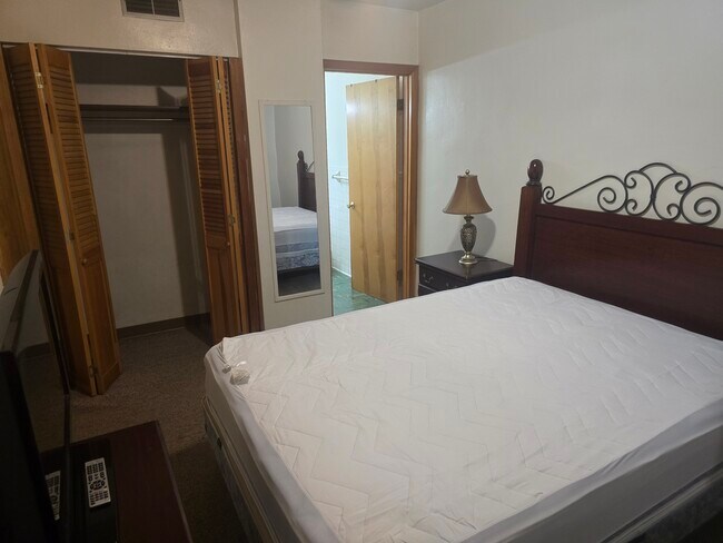 1st BEDROOM... LARGE CLOSET...BEAUTIFUL BED .... MIRROR DRESSER - 1216 University Ave