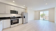 Located at 433 Rosenell Terr in the Silver Lake neighborhood of Los Angeles, this thoughtfully designed 3-bedroom, 2-bathroom unit offers a clean, modern aesthetic throughout its single-floor layout. Light wood flooring flows seamlessly across every room, creating a cohesive and airy atmosphere.

The kitchen is a standout feature, outfitted with a full suite of stainless steel appliances — including a French door refrigerator, electric range, built-in microwave, and dishwasher — paired with crisp white shaker cabinets and striking dark granite countertops. The kitchen opens directly into the living area, which benefits from natural light and access to a private balcony with outdoor views.

The two bathrooms are finished in a clean, contemporary style with light wood flooring, white tile surrounds, tub-shower combos, and dark-topped vanities that echo the kitchen's design language. Each bedroom features the same warm flooring and neutral white walls. One bedroom includes floor-to-ceiling mirrored sliding closet doors that enhance the sense of space, while the primary bedroom offers a comfortable, well-proportioned layout. A connecting hallway with recessed lighting ties the rooms together efficiently. Recessed lighting throughout adds to the bright, modern feel of this well-appointed Los Angeles home.