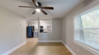 Located at 51 Montague Rd in Greenville, SC, this efficiently designed one-bedroom, one-bathroom unit offers a well-organized single-floor layout. The living room is bright and welcoming, featuring light wood-style flooring, neutral gray walls, crisp white baseboards, and a ceiling fan that enhances airflow and comfort. Natural light filters in through blinds-fitted windows, giving the space an open, airy feel.

The kitchen is thoughtfully designed with white shaker-style cabinetry, light quartz countertops, and a full suite of black appliances including a refrigerator, electric range, microwave, and dishwasher. A pass-through window connects the kitchen to the living area, promoting an open and functional flow.

The bedroom is carpeted for comfort and includes a ceiling fan, two closets, and a window with an outdoor view of the surrounding neighborhood. The bathroom features a full tub-shower combo with clean white surrounds and modern matte black hardware accents.

Additional highlights include wood-style flooring in the main living areas, multiple ceiling fans across rooms, and two closets providing ample storage. The layout makes efficient use of space throughout, offering a comfortable and practical living environment in Greenville.