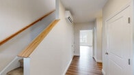 Located at 5 Eagle Brook Blvd in Wrentham, MA, this well-appointed three-bedroom, three-bathroom home spans three floors, offering a thoughtful layout with generous living space throughout. The attached garage on the ground level provides convenient interior access and includes an automatic opener and electrical panel. An unfinished basement offers excellent storage or future finishing potential, with visible insulation and utility infrastructure already in place. The main living floor features an open-concept kitchen and living area finished with warm hardwood-style flooring. The kitchen is outfitted with crisp white shaker cabinetry, light countertops, a stainless steel dishwasher, and an undermount sink — delivering a clean, modern aesthetic. Large windows flood the living area with natural light and offer views of the surrounding neighborhood and green landscape. The upper floor hosts the bedrooms, including a spacious primary suite with plush carpeting, a walk-in closet featuring dual hanging rods, and its own bathroom. Additional bedrooms are well-proportioned with carpet flooring and bright windows. Three full bathrooms, including clean tub/shower combinations, serve the home's occupants comfortably. A dedicated laundry area and multiple hallways complete this functional and well-designed home.
