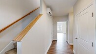 Located at 5 Eagle Brook Blvd in Wrentham, MA, this well-appointed three-bedroom, three-bathroom home spans three floors, offering a thoughtful layout with generous living space throughout. The attached garage on the ground level provides convenient interior access and includes an automatic opener and electrical panel. An unfinished basement offers excellent storage or future finishing potential, with visible insulation and utility infrastructure already in place. The main living floor features an open-concept kitchen and living area finished with warm hardwood-style flooring. The kitchen is outfitted with crisp white shaker cabinetry, light countertops, a stainless steel dishwasher, and an undermount sink — delivering a clean, modern aesthetic. Large windows flood the living area with natural light and offer views of the surrounding neighborhood and green landscape. The upper floor hosts the bedrooms, including a spacious primary suite with plush carpeting, a walk-in closet featuring dual hanging rods, and its own bathroom. Additional bedrooms are well-proportioned with carpet flooring and bright windows. Three full bathrooms, including clean tub/shower combinations, serve the home's occupants comfortably. A dedicated laundry area and multiple hallways complete this functional and well-designed home.
