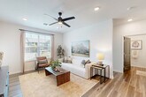 Located at 4660 Derrick Rd in Union City, GA, this single-story, 3-bedroom, 1-bathroom home offers a thoughtfully designed layout with modern finishes throughout. Wood-look flooring flows continuously across the entire home, creating a cohesive and clean aesthetic.

The open-concept living, dining, and kitchen area serves as the heart of the home. The bright living room features large windows that invite abundant natural light and outdoor views, complemented by a ceiling fan overhead. The kitchen is well-appointed with light wood cabinetry, granite countertops, stainless steel appliances — including a refrigerator, range, microwave, and dishwasher — and a central island with bar seating, ideal for casual dining.

The primary bedroom is a comfortable retreat, featuring a ceiling fan and access to the bathroom, which includes a granite-topped vanity and a walk-in shower. The two additional bedrooms are well-sized and naturally lit, each with easy closet access. The home includes five closets in total, providing ample storage throughout. A dedicated laundry area and utility room add practical convenience.

A hallway connects the bedroom wing to the main living spaces, lined with distinctive dark-paneled doors that add a modern contrast to the bright white walls. The overall ambiance is clean, contemporary, and move-in ready.