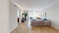 Located at 1001 Starbucks St in Fullerton, CA, this well-appointed 2-bedroom, 2-bathroom single-floor residence offers a thoughtfully designed layout across a comfortable footprint. The living room serves as the heart of the home, featuring warm hardwood-style flooring, elegant crown molding, a ceiling fan, and a sliding glass door that opens onto a private balcony overlooking a lush canopy of mature trees. The kitchen is outfitted with white shaker cabinetry, light quartz countertops, stainless steel appliances, and wood-style tile flooring that enhances its bright, clean aesthetic. Both bedrooms are carpeted and include ceiling fans and windows with blinds that allow for ample natural light. The primary bedroom offers a cozy, well-proportioned retreat. The two bathrooms are finished in a neutral palette, each featuring a tub-shower combination, wood-style flooring, and a vanity with understated cabinetry. A connecting hallway ties the layout together efficiently. Throughout the residence, a cohesive neutral color scheme, consistent finishes, and practical features create a calm and functional living environment suited for everyday comfort in the heart of Orange County.