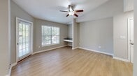 Located at 1000 Park Place Ave in Morrisville, NC, this well-appointed one-bedroom, one-bathroom residence offers a thoughtfully designed single-floor layout that maximizes both comfort and functionality. The open-concept kitchen and living area serves as the heart of the home, featuring light hardwood-style flooring, a ceiling fan, and large windows fitted with blinds that invite generous natural light and views of the surrounding greenery. A sliding glass door provides additional outdoor access and further brightens the space.

The kitchen is a standout, showcasing white shaker-style cabinetry, striking granite countertops, a dark subway tile backsplash, and a full suite of stainless steel appliances including a refrigerator, range, microwave, and dishwasher. A built-in countertop peninsula adds extra workspace and a casual dining option.

The bedroom offers plush carpeting, a ceiling fan, a walk-in closet, and direct access to the bathroom — which features wood-look flooring, white cabinetry, a marble-style countertop, and a sleek medicine cabinet with mirror. A dedicated in-unit laundry area with full-size washer and dryer hookups and overhead wire shelving adds everyday convenience. Neutral tones and clean finishes throughout create a cohesive, move-in-ready atmosphere.