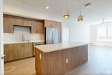 Located at 3585 Aero Ct in San Diego, CA 92123, this modern 2-bedroom, 2-bathroom residence spans 1,080 square feet of thoughtfully designed single-floor living. Light wood-look flooring runs throughout, complementing a bright, neutral palette that maximizes the natural light flowing in from large sliding windows.

The open-concept kitchen and living area serves as the heart of the home. The kitchen features flat-front wood-tone cabinetry with brushed gold hardware, quartz countertops, a tile backsplash, stainless steel appliances including a gas range, built-in microwave, dishwasher, and refrigerator, plus a central island with pendant lighting.

The primary bedroom measures 200 square feet and includes direct access to a private balcony with outdoor views, a ceiling fan, and a walk-in closet with built-in shelving and dual hanging rods. The en-suite bathroom offers a long vanity with wood cabinetry, LED-lit mirror, and a glass-enclosed shower. The second bedroom is bright and generously sized with large windows and ample natural light. The second bathroom features a soaking tub and shower combo with large-format tile surround and brushed nickel fixtures. Both closets are well-appointed, completing this clean, contemporary San Diego residence.
