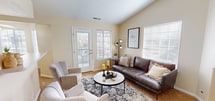 This 650 square foot apartment in Layton, Utah, offers a blend of comfort and contemporary design. The space efficiently accommodates two bedrooms, including a primary bedroom of 200 square feet, and one bathroom. The open-concept living area combines the kitchen, living room, and dining space, creating a seamless flow for daily activities.

The kitchen is galley-style, featuring light-colored cabinetry, a full suite of appliances, and ample counter space. The living room boasts a cozy fireplace and large windows that flood the space with natural light. A standout feature is the arched window in one of the bedrooms, adding architectural interest and views.

The bathroom showcases a modern white tub-shower combo with sleek fixtures. Throughout the apartment, neutral tones dominate, creating a bright and airy atmosphere. Carpeting in the bedrooms and living areas adds warmth, while the kitchen appears to have easy-to-clean flooring.

Storage solutions are integrated throughout, including closet space and kitchen cabinetry. The apartment's layout maximizes the use of space, making it feel larger than its actual square footage. This property is well-suited for individuals or small families seeking a contemporary living space in a convenient Layton location.