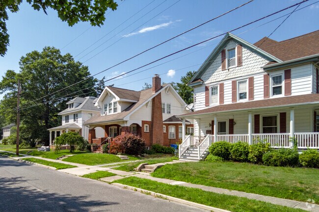Spacious Colonial Revival homes of varied styles line Glassboro streets.