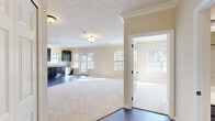 Located in Cranberry Township, PA, this single-story, three-bedroom, two-bathroom home offers a well-designed layout with a cohesive, neutral aesthetic throughout. The open living and dining area is anchored by rich hardwood-style flooring and abundant natural light streaming in through multiple windows, creating a bright and welcoming atmosphere. Crown molding adds a refined architectural touch to the main living space.

The kitchen is a standout feature, outfitted with dark espresso cabinetry, granite-look countertops, stainless steel appliances including a refrigerator, range, microwave, and dishwasher, and a dedicated pantry closet for additional storage. Hardwood-style flooring continues throughout the kitchen, which also benefits from recessed lighting and direct access to an outdoor deck area.

The bedrooms are finished with plush carpeting and receive ample natural light. The primary bedroom includes a walk-in closet with wire shelving, while secondary bedrooms feature standard closets with built-in rods. Both bathrooms are finished with dark cabinetry and white countertops; the primary bath offers a dual-sink vanity with a large mirror, while the second bath includes a tub/shower combination. The home also features an in-unit laundry area, completing this practical and comfortable layout.