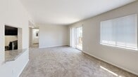 Located at 6525 Greenway Dr in Roanoke, Virginia, this single-floor residence offers a clean, well-maintained layout with a neutral color palette and an abundance of natural light throughout. The spacious living area is anchored by plush wall-to-wall carpeting and features a sliding glass door that opens to a private balcony, offering pleasant outdoor views of surrounding greenery. An additional window further fills the space with natural light, creating a bright and welcoming atmosphere.

The kitchen is thoughtfully designed with a galley-style layout, showcasing white cabinetry with modern brushed nickel hardware, marbled laminate countertops, and light wood-look flooring. Stainless steel appliances, including a dishwasher and refrigerator, complete the functional and contemporary feel of the space.

The bedrooms are comfortably sized, each finished with soft carpeting and fitted with windows dressed in white blinds that allow for adjustable natural light. The neutral tones of the walls and floors carry throughout, lending a cohesive and calm ambiance to every room. A bathroom with vanity lighting and white cabinetry is accessible from the main living area. The overall layout, as seen in the dollhouse view, is efficient and open, making excellent use of the available space.