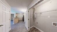 Located at 8027 Glimmer Way in Louisville, Kentucky, this single-floor, 2-bedroom, 2-bathroom home offers a practical and well-organized layout. The galley-style kitchen is equipped with light maple cabinetry, a double-basin stainless steel sink, a full suite of black appliances including a refrigerator, electric range, and dishwasher, and durable wood-look flooring that ties the space together with a clean, modern feel. A hallway connects the main living areas to the private quarters, which include a dedicated closet for additional storage. Both bedrooms feature soft, neutral-toned carpet, textured ceilings, and windows that allow natural light to brighten each room. The primary bedroom offers a generous footprint, providing ample space for furnishings. The secondary bedrooms are comparably comfortable with similar finishes. Each of the two bathrooms is finished with warm beige tile flooring, a wood-toned vanity with a single sink, and a full tub and shower combination, offering functional and consistent design throughout. Neutral wall tones are used consistently across all rooms, creating a cohesive and easy-to-personalize aesthetic. The overall layout is efficient, making smart use of its footprint while maintaining a comfortable living environment.
