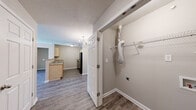 Located at 8027 Glimmer Way in Louisville, Kentucky, this single-floor, 2-bedroom, 2-bathroom home offers a practical and well-organized layout. The galley-style kitchen is equipped with light maple cabinetry, a double-basin stainless steel sink, a full suite of black appliances including a refrigerator, electric range, and dishwasher, and durable wood-look flooring that ties the space together with a clean, modern feel. A hallway connects the main living areas to the private quarters, which include a dedicated closet for additional storage. Both bedrooms feature soft, neutral-toned carpet, textured ceilings, and windows that allow natural light to brighten each room. The primary bedroom offers a generous footprint, providing ample space for furnishings. The secondary bedrooms are comparably comfortable with similar finishes. Each of the two bathrooms is finished with warm beige tile flooring, a wood-toned vanity with a single sink, and a full tub and shower combination, offering functional and consistent design throughout. Neutral wall tones are used consistently across all rooms, creating a cohesive and easy-to-personalize aesthetic. The overall layout is efficient, making smart use of its footprint while maintaining a comfortable living environment.