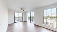 Located at 4181 Davie Rd in Davie, Florida, this well-appointed 4-bedroom, 2-bathroom home offers a modern and functional layout across a single floor. Wide-plank wood-look flooring runs throughout, lending warmth and continuity to the space.

The open-concept living room and kitchen area serves as the heart of the home. Floor-to-ceiling sliding glass doors lead to a private balcony, flooding the space with natural light and offering expansive views of the surrounding Davie landscape. Large black-framed windows further enhance the bright, airy atmosphere.

The kitchen is outfitted with white cabinetry, a contrasting dark tile backsplash, quartz countertops, a generous island, stainless steel appliances, and stylish pendant lighting — combining form and function seamlessly.

The four bedrooms are bright and well-proportioned, each featuring black-framed windows with outdoor views. The primary bedroom includes a walk-in closet with built-in shelving, drawers, and hanging rods for ample storage.

The two bathrooms are finished in a clean, contemporary style. One features a glass-enclosed walk-in shower with large-format tile, a wood-tone vanity, and marble-look flooring. The second offers a tiled tub-shower combination with brushed nickel fixtures. Together, these spaces reflect a cohesive, modern aesthetic throughout.