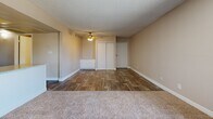Located at 10201 N 33rd Ave in Phoenix, Arizona, this single-story home offers three bedrooms and two bathrooms across a well-organized floor plan. The living room is a welcoming, open space featuring plush carpeting, a textured ceiling, and a sliding glass door that fills the room with natural light and provides access to an outdoor area with views of surrounding greenery.

The kitchen is efficiently designed with white cabinetry, speckled countertops, wood-look flooring, and black appliances including a refrigerator, dishwasher, and range. A window brings in additional natural light, enhancing the functional workspace.

The bedrooms are carpeted and feature sliding closet doors for storage, neutral-toned walls, and ceiling fans where applicable for year-round comfort. The primary bedroom offers a generous layout with ample closet space.

The two bathrooms are clean and practical. One includes a tub-shower combination with wood-look tile flooring, while the second features a separate water closet and a vanity with speckled countertops, maintaining a cohesive aesthetic throughout.

Overall, the home presents a straightforward, functional design with consistent finishes, including wood-look flooring in common areas and bathrooms, carpet in the bedrooms, and neutral warm tones throughout.
