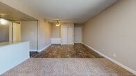Located at 10201 N 33rd Ave in Phoenix, Arizona, this single-story home offers three bedrooms and two bathrooms across a well-organized floor plan. The living room is a welcoming, open space featuring plush carpeting, a textured ceiling, and a sliding glass door that fills the room with natural light and provides access to an outdoor area with views of surrounding greenery.

The kitchen is efficiently designed with white cabinetry, speckled countertops, wood-look flooring, and black appliances including a refrigerator, dishwasher, and range. A window brings in additional natural light, enhancing the functional workspace.

The bedrooms are carpeted and feature sliding closet doors for storage, neutral-toned walls, and ceiling fans where applicable for year-round comfort. The primary bedroom offers a generous layout with ample closet space.

The two bathrooms are clean and practical. One includes a tub-shower combination with wood-look tile flooring, while the second features a separate water closet and a vanity with speckled countertops, maintaining a cohesive aesthetic throughout.

Overall, the home presents a straightforward, functional design with consistent finishes, including wood-look flooring in common areas and bathrooms, carpet in the bedrooms, and neutral warm tones throughout.