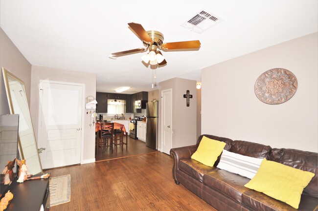 Living room and kitchen with hardwood floors - 2119 N Grand Blvd