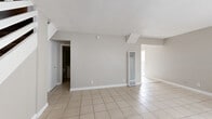 Located at 1425 W Stoneridge Ct in Ontario, CA, this two-story, 2-bedroom, 2-bathroom home offers a practical and functional layout spread evenly across two floors. The main level features a bright living room with light-toned ceramic tile flooring, textured ceilings, and a window fitted with vertical blinds that draws in natural light. A wall-mounted AC unit provides climate control. The combined kitchen and dining area is well-appointed with white cabinetry, granite-style countertops, a gas range, and a dedicated pantry for additional storage. A full bathroom on the main level features a tiled soaking tub and a vanity with under-cabinet storage. Upstairs, both bedrooms are finished with warm hardwood flooring and feature vertical-blind windows that allow natural light to filter in. The primary bedroom includes a sliding-door closet, while the second bedroom is equally comfortable. The upper level is served by a second full bathroom with tile flooring. Additional highlights include multiple closets throughout, two staircases, hallways connecting key areas, a utility room, and a private patio — ideal for outdoor relaxation. The home's neutral color palette and clean finishes create a versatile and move-in-ready living environment.