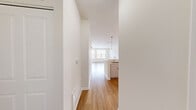 Located at 1930 Ridge Ave in Evanston, IL, this well-appointed single-floor unit offers a thoughtfully designed open-concept layout that maximizes every square foot. Light hardwood flooring runs throughout the space, complementing the clean white walls and creating a warm, cohesive aesthetic.

The combined kitchen and living area serves as the heart of the unit. The kitchen is outfitted with white shaker-style cabinetry, a white subway tile backsplash, and a full suite of stainless steel appliances including a gas range, microwave, dishwasher, and refrigerator. A peninsula with a white quartz countertop provides additional prep space and casual seating, while pendant lighting overhead adds a modern finishing touch. Track lighting further illuminates the kitchen workspace.

The living area is bright and airy, benefiting from multiple large windows fitted with horizontal blinds that allow for natural light control. Views of the surrounding neighborhood greenery are visible through the windows, lending a pleasant outdoor connection.

The bathroom features a full tub-and-shower combination with white tile surround, a vanity with sink, and clean, classic fixtures throughout.

Additional features include a closet for storage and a layout that offers flexible furnishing options. The unit's neutral palette and modern finishes make it a versatile and inviting living space in the heart of Evanston.