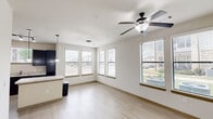 Located in Katy, TX, this 2-bedroom, 1-bathroom residence offers a well-organized single-floor layout designed for comfortable everyday living. The open-concept living, dining, and kitchen area serves as the heart of the home, bathed in natural light from multiple windows fitted with blinds. Ceiling fans in the living area and both bedrooms enhance airflow and comfort. The kitchen is outfitted with dark espresso cabinetry, light granite-style countertops, black appliances including a refrigerator, electric range with over-the-range microwave, and a double-basin sink — providing ample functionality. Light wood-style flooring flows seamlessly throughout the entire space, creating a clean and cohesive aesthetic. The hallways connect the living areas to two well-sized bedrooms, each featuring ceiling fans and exterior-facing windows that bring in natural light and neighborhood views. Three closets — including a double-door closet in the primary bedroom — offer generous storage. The bathroom includes a dark-toned vanity with granite countertop and wall-mounted cabinetry. A dedicated laundry area and a private balcony round out the practical amenities. Louvered bifold closet doors and paneled interior doors add a classic design touch throughout.