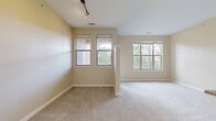 This 710-square-foot, one-bedroom, one-bathroom apartment is located on the second floor at 9850 Zenith Meridian Drive in Englewood, Colorado. The unit is thoughtfully laid out across a single floor, encompassing a combined kitchen and living room, one bedroom, one bathroom, a closet, and a hallway. The kitchen is a standout feature, equipped with rich dark-wood cabinetry, granite countertops, a subway tile backsplash, stainless steel appliances — including a refrigerator, range, and over-the-range microwave — and a peninsula island with built-in shelving and pendant lighting. Hardwood-style flooring runs throughout the kitchen area, while soft, neutral-toned carpet extends through the living room and bedroom. The living room benefits from track lighting and multiple windows that invite natural light. The primary bedroom measures 160 square feet and features a large window overlooking lush greenery, providing a serene outdoor view, along with access to a dedicated closet. The bathroom is finished with a wood-tone vanity with granite countertops, a tiled tub-shower combination, and hardwood-style flooring. Warm beige walls and white trim throughout lend a clean, cohesive aesthetic to the entire unit.