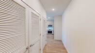 Located at 2720 Bristlecone Trail in Raleigh, NC, this thoughtfully designed one-bedroom, one-bathroom residence offers a clean, modern aesthetic across a single floor. Light wood-tone flooring runs throughout, complementing the bright white walls and recessed lighting that create a fresh, airy atmosphere.

The open-concept kitchen serves as the centerpiece of the living area, featuring two-tone cabinetry, a white subway tile backsplash, stainless steel appliances including a range, microwave, dishwasher, and refrigerator, along with a white quartz center island ideal for dining or meal prep. The kitchen flows seamlessly into the living area, which is brightened by multiple windows and a ceiling fan.

The hallway leading to the bedroom includes louvered closet doors that provide convenient storage access. The bedroom is a comfortable, well-lit space with multiple windows dressed in blinds, warm wood flooring, and a ceiling fan.

The bathroom is clean and functional, offering a tiled soaking tub and shower combination, a modern vanity with white countertop and under-cabinet storage, and wood-look flooring. A dedicated walk-in closet adjacent to the bedroom provides ample storage with multi-tiered wire shelving. This residence combines practicality and modern design in a cohesive, move-in-ready layout.