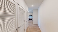 Located at 2720 Bristlecone Trail in Raleigh, NC, this thoughtfully designed one-bedroom, one-bathroom residence offers a clean, modern aesthetic across a single floor. Light wood-tone flooring runs throughout, complementing the bright white walls and recessed lighting that create a fresh, airy atmosphere.

The open-concept kitchen serves as the centerpiece of the living area, featuring two-tone cabinetry, a white subway tile backsplash, stainless steel appliances including a range, microwave, dishwasher, and refrigerator, along with a white quartz center island ideal for dining or meal prep. The kitchen flows seamlessly into the living area, which is brightened by multiple windows and a ceiling fan.

The hallway leading to the bedroom includes louvered closet doors that provide convenient storage access. The bedroom is a comfortable, well-lit space with multiple windows dressed in blinds, warm wood flooring, and a ceiling fan.

The bathroom is clean and functional, offering a tiled soaking tub and shower combination, a modern vanity with white countertop and under-cabinet storage, and wood-look flooring. A dedicated walk-in closet adjacent to the bedroom provides ample storage with multi-tiered wire shelving. This residence combines practicality and modern design in a cohesive, move-in-ready layout.
