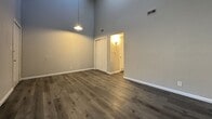 This 460 square foot apartment in Topeka, Kansas, offers a well-designed living space that maximizes functionality. The single-floor layout comprises one bedroom, one bathroom, and a living room, making it suitable for individuals or couples.

The apartment boasts modern wood-look flooring throughout, creating a cohesive and contemporary aesthetic. High ceilings contribute to a sense of spaciousness, particularly noticeable in the living area and bedroom. The living room is a standout feature, featuring a charming brick fireplace that serves as a focal point and adds warmth to the space.

The bedroom, measuring 240 square feet, is generously sized for the overall apartment dimensions. It offers ample room for a bed and additional furniture, with a window providing natural light. The bathroom is efficiently designed with a vanity, toilet, and a tub-shower combination.

The kitchen, while compact, appears to be well-equipped with essential appliances and cabinetry. Multiple windows throughout the apartment ensure good natural lighting, complemented by recessed and pendant lighting fixtures.

White walls and trim create a bright, clean canvas, allowing for personalization of the space. The apartment's layout and features make it an ideal choice for those seeking a cozy, low-maintenance living environment in an urban setting.