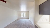 Located at 824 W Gurley St in Prescott, Arizona, this single-floor, 3-bedroom, 1-bathroom home offers a functional and straightforward layout ideal for those seeking comfortable living in a scenic high-desert setting. The floor plan connects a kitchen area — equipped with appliances and cabinetry — to the main living spaces via a central hallway.

The primary bedroom is notably spacious, featuring plush carpet flooring, neutral wall tones, and a window that frames views of the surrounding native Arizona vegetation. It also benefits from access to a dedicated closet. The two additional bedrooms are similarly finished with carpet flooring and cream-colored walls, each offering windows that bring in natural light and overlook the lush, tree-filled outdoor surroundings.

The single bathroom features wood-look vinyl plank flooring, a vanity with gray cabinetry and a white countertop, chrome fixtures, and a tub/shower combination with clean white surround panels. The kitchen, visible in the dollhouse view, includes upper and lower cabinetry, a range, and built-in appliances, making efficient use of the available space. Throughout the home, the clean, neutral palette and consistent finishes create a cohesive and move-in-ready environment, well-suited for the natural charm of the Prescott area.