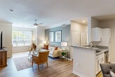 This thoughtfully designed residence in Birmingham, Alabama features two bedrooms, three bathrooms, and a single-level floor plan that maximizes both comfort and functionality. Light hardwood-style flooring flows throughout, complemented by crown molding and a neutral color palette that creates a bright, cohesive ambiance.

The open-concept living, dining, and kitchen area forms the heart of the home. The living room features a ceiling fan, accent wall, and large windows that invite abundant natural light. The kitchen is outfitted with white shaker cabinetry, granite countertops, stainless steel appliances including a refrigerator, range, and built-in microwave, and a peninsula that connects seamlessly to the dining space.

The primary bedroom is generously sized, featuring a ceiling fan, a soothing blue-gray accent wall, and ample closet storage. The second bedroom also offers natural light, a ceiling fan, and comfortable proportions. The bathrooms are well-appointed with granite vanity tops, white cabinetry, and a tiled tub-shower combination in one full bath.

Additional highlights include a dedicated laundry room with a full-size GE washer and dryer and wire shelving above. With four closets throughout, storage is plentiful. The overall design balances modern finishes with a warm, inviting atmosphere.