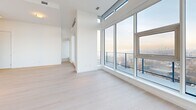 Located on the 43rd floor at 660 Quayside Drive in New Westminster, this generously proportioned 3-bedroom, 3-bathroom residence offers a refined living experience defined by modern design and spectacular panoramic views. Light-toned hardwood flooring flows throughout, complementing a bright, neutral palette that enhances the sense of openness across every room.

The open-concept living, dining, and kitchen area is anchored by expansive floor-to-ceiling windows that frame breathtaking views of the Fraser River, surrounding bridges, and the greater Vancouver skyline. The gourmet kitchen features sleek flat-panel cabinetry in warm wood tones, a dramatic marble hood surround, premium built-in appliances, a gas cooktop, and a large waterfall island — all set against a marble backsplash with under-cabinet lighting.

Each of the three bedrooms is well-proportioned, with the generously sized primary suite offering dedicated closet space. The primary ensuite is a spa-inspired retreat finished in full marble tile, featuring a freestanding soaker tub, glass-enclosed walk-in rain shower, double vanity with warm under-lighting, and large backlit mirrors. Additional bathrooms maintain the same elevated marble finishes. A dedicated laundry room with side-by-side washer and dryer, a pantry, and multiple closets add everyday practicality. The private balcony delivers unobstructed high-rise views.