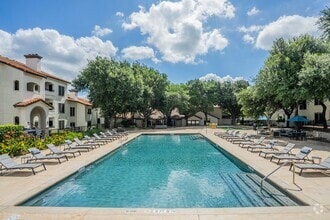 Large Community Pool with Poolside Seating and Adjacent Tree-Lined Walkway - Mesa Verde