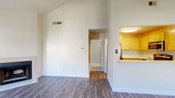 Located at 8123 Sunrise Blvd in Citrus Heights, CA, this one-bedroom, one-bathroom residence offers a well-organized single-floor layout that makes efficient use of its space. The living room is immediately striking, featuring dramatically vaulted ceilings that lend an open, airy feel well beyond the unit's footprint. A tile-surround fireplace anchors the main living area, complemented by a sliding glass door that brings in natural light and provides outdoor access. Wood-style plank flooring runs throughout the living and kitchen areas, adding warmth and continuity.

The kitchen is designed with functionality in mind, featuring a pass-through breakfast bar that opens directly to the living room. Light wood cabinetry provides ample storage, while stainless steel appliances — including a refrigerator, electric range, and built-in microwave — complete the space efficiently.

The bedroom is a comfortable, carpeted retreat with natural light from a window and a full-width mirrored sliding closet that enhances the sense of space. The bathroom includes a wood-toned vanity with a light stone-style countertop, a large mirror, and hardwood-style flooring. A hallway connects the rooms with a closet nearby for additional storage, rounding out this thoughtfully designed residence.