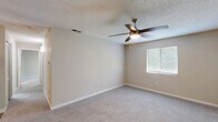 Located at 10920 Covington Bypass Rd in Covington, GA, this single-floor, 2-bedroom, 2-bathroom home offers a practical and comfortable layout with clean, neutral finishes throughout. The kitchen is equipped with stainless steel appliances, including a refrigerator and electric range, complemented by white cabinetry with black hardware, white quartz countertops, a classic subway tile backsplash, and durable wood-style flooring. Both bedrooms are carpeted and filled with natural light from windows fitted with blinds. The spacious primary bedroom features mirrored sliding closet doors and direct access to its own bathroom. The second bedroom includes a closet and shares a similarly well-appointed bathroom. Both bathrooms feature wood-style flooring, white vanities with quartz countertops, round mirrors with modern lighting fixtures, and a tub-shower combination. Hallways connect the rooms efficiently, maintaining a smooth flow throughout the home. The interior palette of warm beiges and whites, paired with textured ceilings, creates a clean and inviting ambiance suitable for comfortable everyday living.