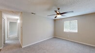 Located at 10920 Covington Bypass Rd in Covington, GA, this single-floor, 2-bedroom, 2-bathroom home offers a practical and comfortable layout with clean, neutral finishes throughout. The kitchen is equipped with stainless steel appliances, including a refrigerator and electric range, complemented by white cabinetry with black hardware, white quartz countertops, a classic subway tile backsplash, and durable wood-style flooring. Both bedrooms are carpeted and filled with natural light from windows fitted with blinds. The spacious primary bedroom features mirrored sliding closet doors and direct access to its own bathroom. The second bedroom includes a closet and shares a similarly well-appointed bathroom. Both bathrooms feature wood-style flooring, white vanities with quartz countertops, round mirrors with modern lighting fixtures, and a tub-shower combination. Hallways connect the rooms efficiently, maintaining a smooth flow throughout the home. The interior palette of warm beiges and whites, paired with textured ceilings, creates a clean and inviting ambiance suitable for comfortable everyday living.