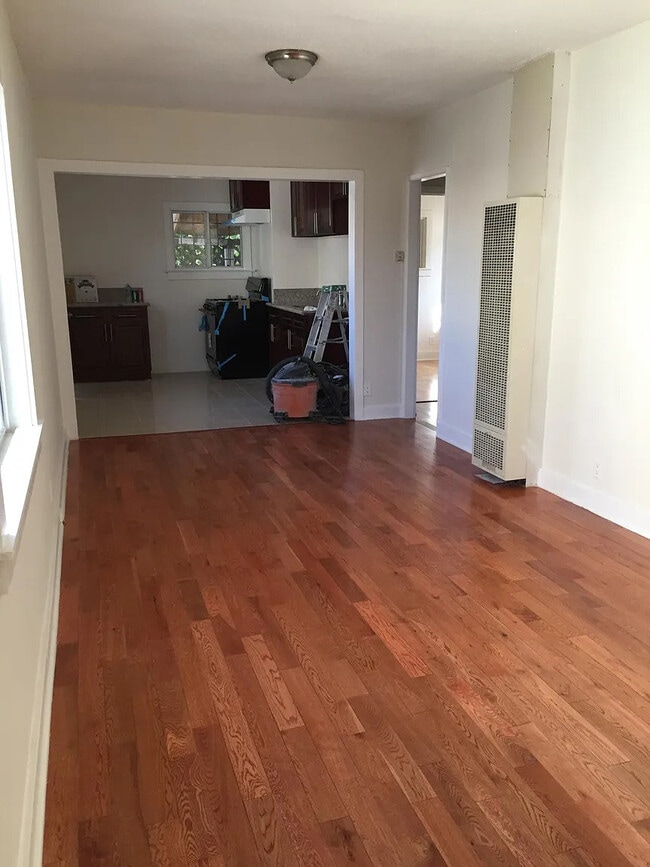 Living room leads to open kitchen - 1680 S Longwood Ave