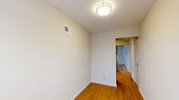 Located at 2 Hazen Court in Wayne, NJ, this one-bedroom, one-bathroom residence offers a well-organized single-floor layout that makes efficient use of its space. Warm-toned hardwood flooring runs throughout the main living areas, lending a cohesive and inviting feel to the home.

The living room is generously proportioned, featuring a large window that draws in natural light and creates an open, airy atmosphere. It flows naturally into the dining area, supporting a comfortable everyday living arrangement. The kitchen stands out with sleek, dark wood-grain cabinetry, granite-style countertops, a stainless steel dishwasher, and a wood floor that ties seamlessly into the rest of the home.

The bedroom is a comfortable, well-lit room with a window overlooking the exterior and a set of louvered bi-fold closet doors providing ample storage. In total, the residence includes three closets, offering exceptional storage capacity throughout. A hallway connects the main spaces with ease.

The bathroom is clean and functional, featuring white subway tile surrounding a full soaking tub with shower, light grey floor tile, and a vanity with white countertop. Neutral wall tones and flush-mount lighting complete the understated, practical aesthetic found throughout this well-maintained Wayne, NJ residence.
