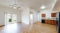 Located at 715 Monnett Ave in Norman, Oklahoma, this single-story 4-bedroom, 3-bathroom home offers a well-organized and functional layout. Warm wood-look flooring flows consistently throughout the home, creating a cohesive and inviting atmosphere.

The combined kitchen and living area serves as the heart of the home. The kitchen is equipped with rich medium-toned cabinetry, a decorative mosaic tile backsplash, light countertops, and a full suite of black appliances including a range, microwave, dishwasher, and refrigerator. The adjacent living room features vaulted ceilings, a ceiling fan, and sliding glass doors that open to a private balcony with views of lush greenery — filling the space with natural light and outdoor connectivity.

The four bedrooms are comfortably sized, each with ceiling fans and windows that bring in natural light and neighborhood views. The primary bedroom provides a quiet retreat with generous proportions.

The three bathrooms are finished with warm diagonal-set stone tile surrounds in the tub/shower areas and coordinating tile flooring, complemented by white vanities with dark hardware. A dedicated laundry room houses a full-size washer and dryer along with the home's mechanical systems. The connecting hallway ties the layout together with a clean, open sightline throughout.