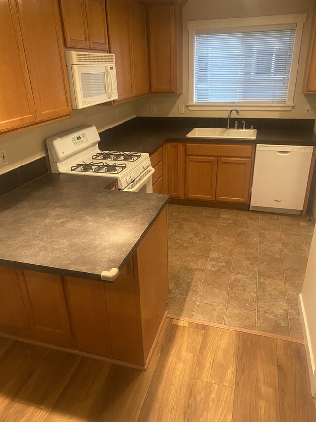 Building Photo - LIKE NEW three bedroom with fantastic updates, one car garage and private newly fenced front patio!