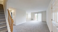 Located at 309 Fox Hill Run Dr in Woodbridge, NJ, this two-story residence offers 2 bedrooms, 3 bathrooms, and a thoughtfully designed layout spread across two floors. The main level features a bright, open living and dining area with plush carpeting, large sliding glass doors that flood the space with natural light, and direct access to a private balcony. The kitchen is well-appointed with rich dark wood cabinetry, granite countertops, light hardwood-style flooring, a stainless steel sink, and stainless appliances — all complemented by a subway tile backsplash. A pantry and adjacent dining room round out the main level's functional flow. A versatile den and an entrance area with hallways add to the flexibility of the first floor. The upper level houses both bedrooms, including a generously sized primary bedroom with a large window and ample natural light. Multiple closets provide excellent storage throughout. The three bathrooms are finished with granite-top vanities, dark wood cabinetry, and tile flooring, with at least one featuring a tub-shower combo with glass enclosure. A dedicated in-unit laundry room with washer hookups and built-in shelving adds everyday convenience. A utility room and staircase with wood railings complete this well-rounded home.