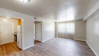 Located at 777 Roanoke Blvd in Salem, Virginia, this single-floor, two-bedroom, one-bathroom residence offers a well-organized layout with a practical and comfortable design. The living room serves as the heart of the home, featuring light wood-style flooring, neutral white walls, and a large window dressed with vertical blinds that allows natural light to fill the space. The front entry opens directly into this open area, providing a welcoming atmosphere.

The kitchen is equipped with warm wood cabinetry, granite-style countertops, and a gas range. A louvered pantry door adds a classic touch while providing convenient storage. Wood-style flooring continues seamlessly throughout the main areas.

Both bedrooms are carpeted for comfort. The primary bedroom features a ceiling fan with light fixture and a window with outdoor views of surrounding greenery. The second bedroom offers a large bi-fold closet door and an additional secondary closet, maximizing storage. Throughout the home, five closets in total provide ample organizational space.

The bathroom is clean and functional, featuring a sliding glass door walk-in shower, a vanity, and matching wood-style flooring. A connecting hallway ties the rooms together efficiently. The overall ambiance is bright, clean, and move-in ready.