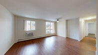 Located at 91 Front Ave W in Brockville, Ontario, this 2-bedroom, 2-bathroom unit offers a practical and comfortable layout across a single floor. Rich hardwood flooring flows throughout the main living areas and bedrooms, creating a warm and cohesive aesthetic.

The spacious living room is a standout feature, bathed in natural light through large windows and a sliding glass door that opens to a balcony with exterior views. A ceiling fan with overhead lighting adds functionality, while baseboard heating ensures year-round comfort. A wall-mounted air conditioning unit provides additional climate control.

The kitchen is efficiently designed in a U-shaped layout, featuring white cabinetry with ample storage, laminate countertops, a stainless steel sink, and white appliances including a refrigerator, electric range, and built-in microwave. Tile flooring completes the space.

The primary bedroom is generously sized and includes a ceiling fan, baseboard heating, and access to a dedicated closet. The second bedroom also features hardwood flooring, a window for natural light, and a sliding-door closet for storage.

Both bathrooms are well-appointed, with one featuring a tiled tub-and-shower combination with chrome fixtures and grab bars. The unit also includes two closets for additional storage throughout.