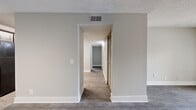 Located at 500 Windsor Green Blvd in Goodlettsville, Tennessee, this single-floor residence offers two bedrooms and three bathrooms within a well-organized, efficiently designed layout. The open-concept kitchen and living area forms the heart of the home, with the kitchen showcasing rich dark-stained cabinetry, white subway tile backsplash, light wood-look flooring, and a full suite of black appliances including a range, refrigerator, and dishwasher. A louvered closet door provides convenient utility storage nearby. The living room extends naturally from the kitchen and features easy-care wood-look flooring and French doors that open to a private balcony, allowing natural light to fill the space. A pendant light fixture adds a subtle decorative touch to the entryway corridor. The bedrooms are carpeted for comfort, with neutral gray-toned walls and windows that invite natural light. The primary bedroom is generously sized and accesses a walk-in closet equipped with built-in shelving and hanging rods. Three full bathrooms, each featuring clean white tub-shower surrounds with chrome fixtures, provide ample convenience for residents and guests alike. A dedicated utility room rounds out the functional layout of this thoughtfully designed Goodlettsville home.