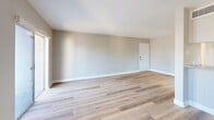 Located at 1915 Maravilla Ave in Fort Myers, FL, this 2-bedroom, 1-bathroom unit offers a clean, modern aesthetic across a well-organized single-floor layout. Light wood plank flooring flows consistently throughout the space, complementing the neutral gray-toned walls and crisp white trim that give the interior a bright, cohesive feel.

The open living and dining area is generously proportioned, with large sliding glass doors leading to a private balcony and additional windows that fill the room with natural light. The galley-style kitchen is thoughtfully updated, featuring white shaker cabinetry, granite countertops, a stainless steel sink, and stainless steel appliances including a range, microwave, dishwasher, and refrigerator. A tray ceiling adds a subtle architectural detail overhead.

Both bedrooms are well-sized and filled with natural light from dedicated windows, with the spacious primary bedroom offering ample room for furnishings. Four closets are distributed throughout the unit, providing excellent storage. The bathroom is clean and functional, featuring a white vanity with a granite countertop, a tub-shower combination, and matching wood-look flooring. A hallway connects the living areas to the private quarters, creating a practical and comfortable flow throughout the home.