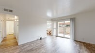 Located at 4444 Central Ave in Fremont, California, this single-story unit offers a clean, bright, and well-organized layout designed for comfortable everyday living. The living area is bathed in natural light, thanks to large sliding glass doors that open directly to an outdoor patio, offering views of the surrounding exterior. Light-toned wood-look flooring runs throughout the main living spaces, enhancing the airy and open feel of the interior.

The kitchen is efficiently designed with white cabinetry, marble-style countertops, and white appliances including a refrigerator, electric range, and over-the-range microwave, providing a cohesive and functional cooking space. The bedroom features plush carpeting, crown molding, and a built-in sliding-door closet with shelving, offering ample storage. An additional room with wood-look flooring provides flexible use as a second bedroom or office space.

The bathroom is finished in a crisp, all-white palette, complete with a marble-style vanity countertop, a full soaking tub with shower, and wood-look tile flooring that ties the space together. Throughout the unit, white walls and clean finishes create a consistent, neutral aesthetic that is both inviting and easy to personalize.