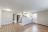 Located at 2622 Swede Road in East Norriton Township, PA, this single-floor 1-bedroom, 1-bathroom unit offers a thoughtfully organized layout across a compact yet functional footprint. The combined dining and living area serves as the heart of the space, featuring light-toned luxury vinyl plank flooring, neutral walls, and a wide window that invites natural light and outdoor views. A wall-unit air conditioner and baseboard heating provide year-round climate control throughout the living areas.

The kitchen is a standout feature, showcasing white upper cabinetry, gray lower cabinetry, a classic subway tile backsplash, and light tile flooring. Stainless steel appliances — including a refrigerator, dishwasher, and range — offer modern functionality, while dual windows keep the space bright and airy. A peninsula-style counter connects the kitchen to the living area, enhancing the open feel.

The spacious bedroom is carpeted for comfort, with natural light provided by a window and easy access to a closet. The full bathroom is cleanly finished in white, complete with a tub/shower combo, a single-sink vanity, and warm wood-look flooring. A dedicated laundry area and hallway round out this efficiently designed home.