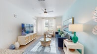 This single-level, one-bedroom, one-bathroom residence in Jacksonville, FL (32256) offers a cohesive coastal aesthetic carried throughout its thoughtfully arranged floor plan. Light wood-style flooring flows continuously across all areas, complementing the bright, neutral wall tones accented by soft blues and greens.

The living area is bathed in natural light from multiple windows dressed with blinds and sheer curtains. A ceiling fan anchors the space overhead, while a soft blue accent wall provides a serene backdrop. The kitchen is well-appointed with white shaker cabinetry extending to the ceiling, granite countertops, a teal glass-tile backsplash, and a full suite of stainless steel appliances, including a side-by-side refrigerator, range, and microwave.

The bedroom features a bold green accent wall, a ceiling fan, and a sun-filled window with outdoor views. The full bathroom includes a granite-topped vanity with white cabinetry, a tub/shower combination, and wood-look flooring. A dedicated laundry closet with a stacked washer and dryer adds practical convenience, while additional built-in shelving provides supplemental storage throughout the home.