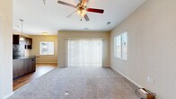 Located at 711 E Cloud Ave in Andover, Kansas, this single-story, one-bedroom, one-bathroom home offers a well-designed layout that maximizes its comfortable footprint. The open-concept living area is bright and inviting, featuring plush carpet flooring, a ceiling fan with light fixture, and multiple windows that fill the space with natural light. A large sliding glass door with vertical blinds connects the living room to the outdoors, enhancing the airy feel of the room.

The kitchen is a standout feature, showcasing rich dark wood cabinetry, granite countertops, a large center island with a sink, and stainless steel appliances including a refrigerator and range. A tasteful tile backsplash and pendant lighting add refined detail, while warm hardwood flooring ties the kitchen and adjacent areas together. A built-in desk area provides a functional workspace within the kitchen zone.

The bedroom is a comfortable, carpeted retreat with a ceiling fan, a window for natural light, and access to a closet. The bathroom is clean and functional, featuring a full tub-shower combo with white surround and hardwood-style flooring. A dedicated laundry area with stacked appliances rounds out this efficient and practical home.